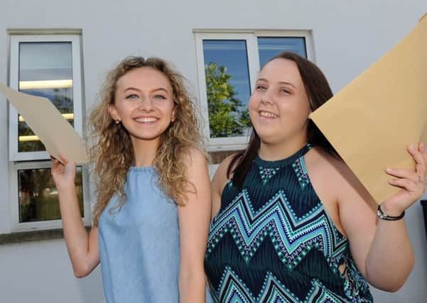 Robyn Corbally-Lidgett (l) and Holly Allen of Handsworth Grange Community Sports College celebrate receiving their GCSE Results. Picture: Andrew Roe