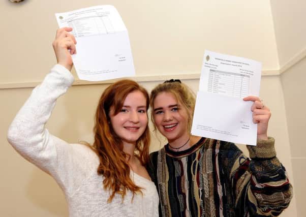 Dronfield Henry Fanshawe School students Elizabeth Critchlow, who achieved seven A*s, four As and a B, and Ella Partidge, two A*s and eight As, celebrate their success. Picture: Andrew Roe