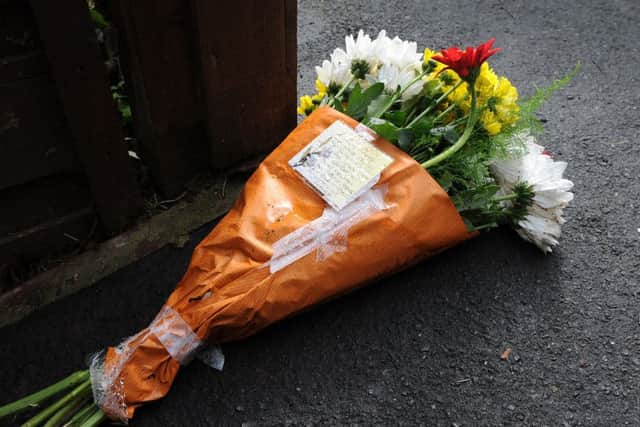 A floral tribute left at the scene of a murder on Fox Walk, Walkley. Picture: Andrew Roe