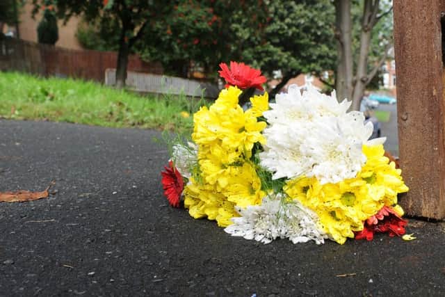 A floral tribute left at the scene of a murder on Fox Walk, Walkley. Picture: Andrew Roe