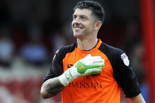 Owls keeper Kieren Westwood after his mistake lead to the Brentford goal gives a relieved smile to the fans at the final whistle. Pic...Steve Ellis