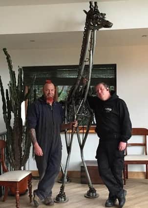 Jonathan Bramwell with sculptor Jason Heppenstall, getting ready to move the four metre tall giraffe.