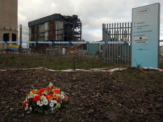 Flowers at the scene at Didcot Power Station, Oxfordshire, as a body recovered from the collapsed boiler house has been identified as that of Christopher Huxtable from Swansea. Photo: Steve Parsons/PA Wire