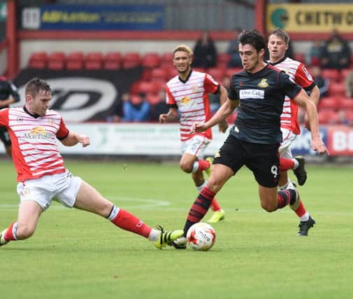 John Marquis is challenged by Crewe's Oliver Turton. Photo: Howard Roe