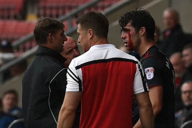 Rovers' John Marquis receives treatment for an eye injury