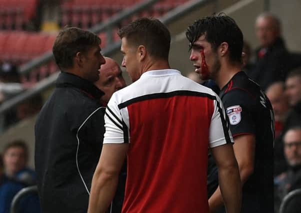 Rovers' John Marquis receives treatment for an eye injury
