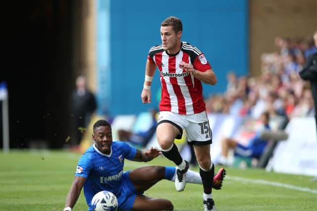 Gillingham's Ryan Jackson tussles with Sheffield United's Paul Coutts