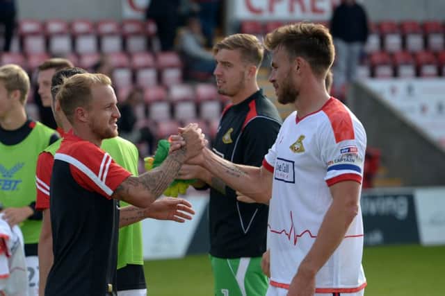 James Coppinger is congratulated by Andy Butler.