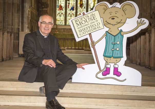 The Reverend Canon Keith Farrow with Sheffield Cathdral's new mascot Rufus the Cathedral Mouse