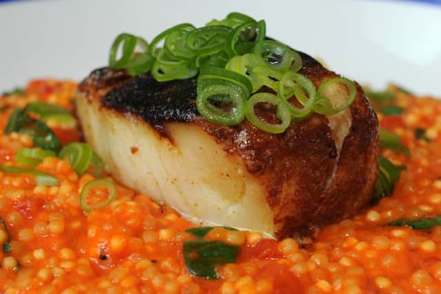 Blackened cod with red pepper and spring onion giant cous cous at the Hope and Anchor, West One. Picture: Andrew Roe