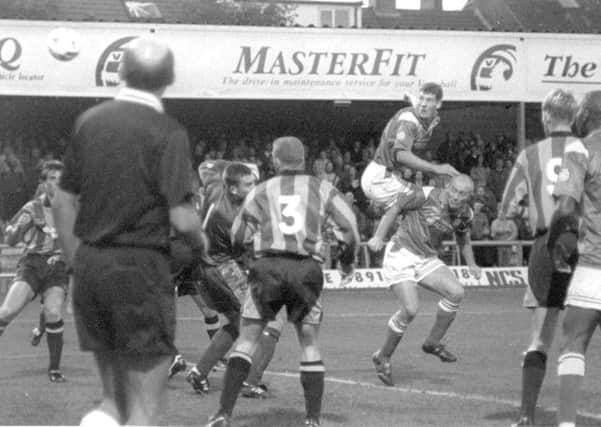 Mark Williams heads the ball for Chesterfield as Nicky Law leaves him to it