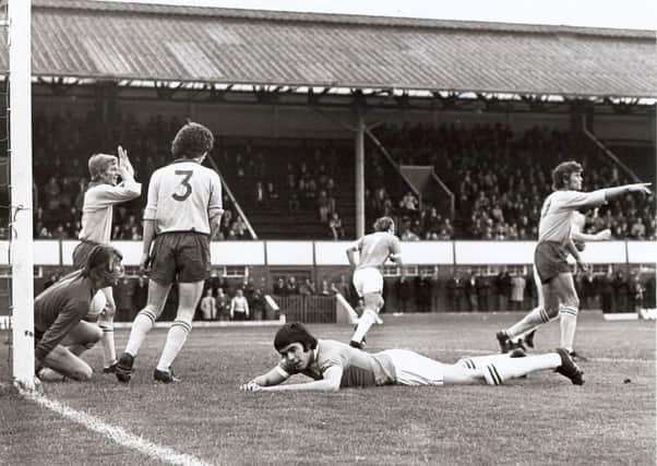 A frustrated Ernie Moss lies prostrate having just failed to beat Shrewsbury goalie Ken Mulhearn to a cross.
Rod Fern has seen enough and makes his way back to face Mulhearns clearance, when it comes, but two Shrews men -  Alan Durban, left, and r Chic Bates  continue an argument about a handball in the build-up.