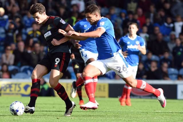 John Marquis is challenged by Gareth Evans. Pictures: Howard Roe