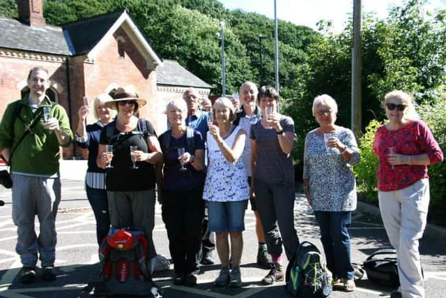 The group celebrate with a glass of champagne in Dore.