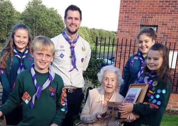 Scouts with a resident at the sensory garden.
