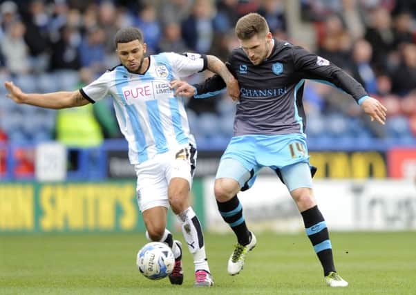 Owls' Gary Hooper with Huddersfield Town's Nahki Wells when Wednesday's visited the John Smith's Stadium last season and came away with a 1-0 win