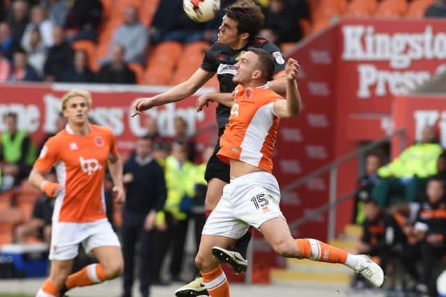 John Marquis up against Blackpool's Tom Aldred
