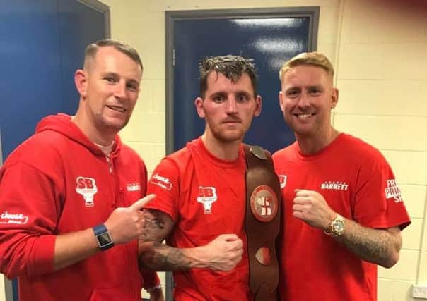 New English lightweight champion Robbie Barrett (centre) with trainers Ray Doyle and Stefy Bull