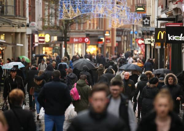 Last minute Christmas shoppers in Nottingham brave heavy rain today on Christmas Eve.