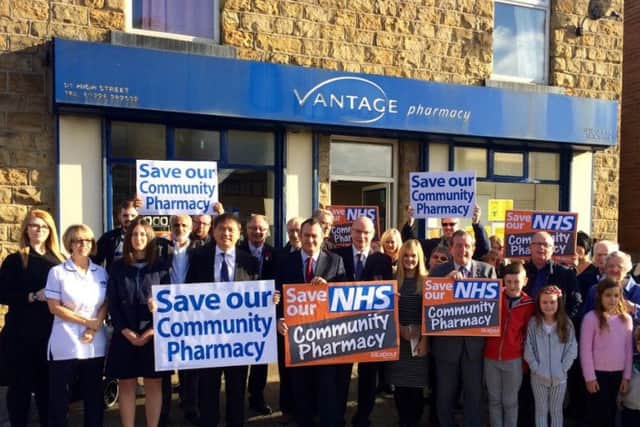 Michael Dugher MP with campaigners outside a pharmacy.