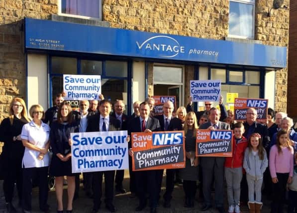 Michael Dugher MP with campaigners outside a pharmacy.