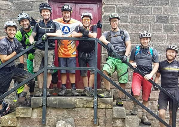 Rob Hobson, middle with grey and orange top, with his biking friends.