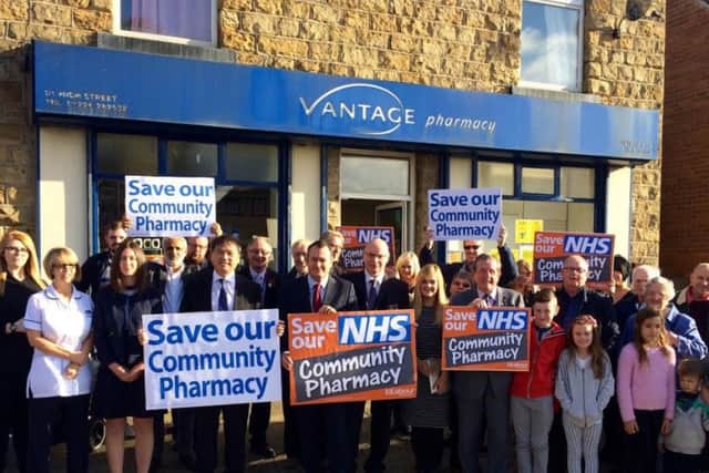 Michael Dugher MP with campaigners outside a pharmacy.
