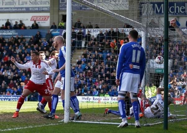 Alex Baptiste tumbles into the net after opening the scoring for Sheffield United against Chesterfield