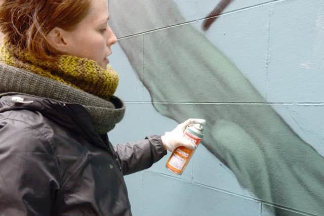 Faunagraphic re-doing the vandalised section of her new mural