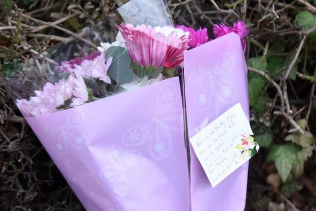 Flowers have been left at the scene of a fatal shed fire