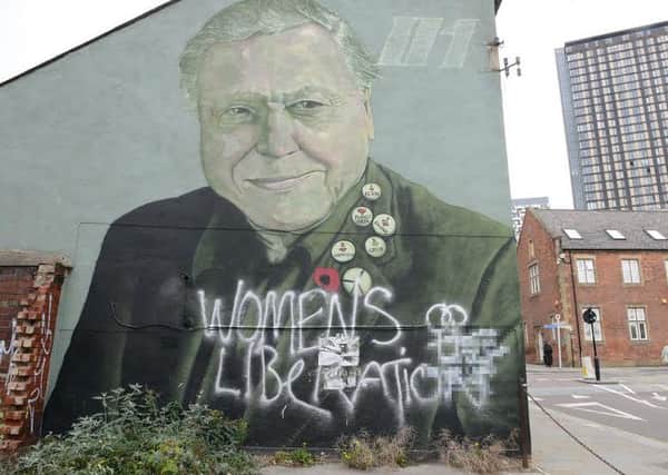 Rocket01's defaced David Attenborough portrait on Charles Street. A message accusing someone of the vandalism has been blurred out in the right corner