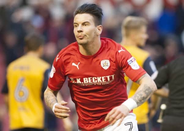 Barnsley's Adam Hammill wheels away after has added-time equaliser. Photo: Dean Atkins