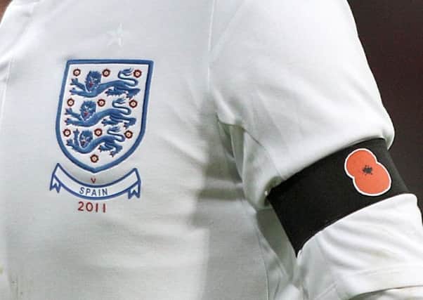 A poppy emblazoned armband adorns the England kit for their friendly with Spain in 2001
