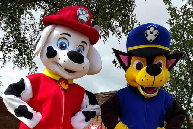 Charachters of Paw Patrol with a young fan ahead of the Christmas lights switch-on.
