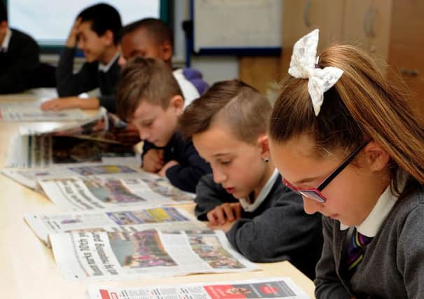 Arbourthorne Primary School pupils read the Star as part of the reader passport project. Picture: Andrew Roe