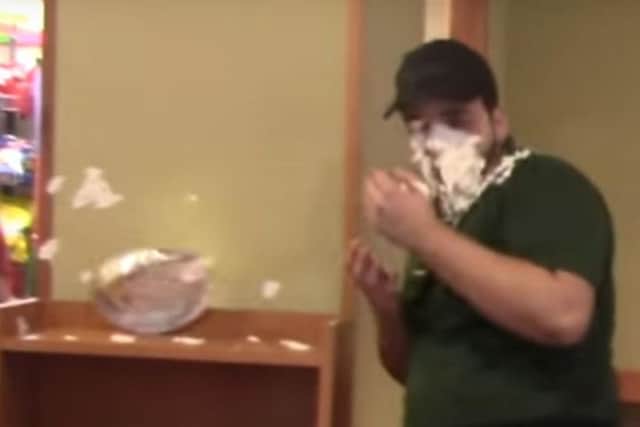 A Subway worker is hit in the face in the video. (YouTube).