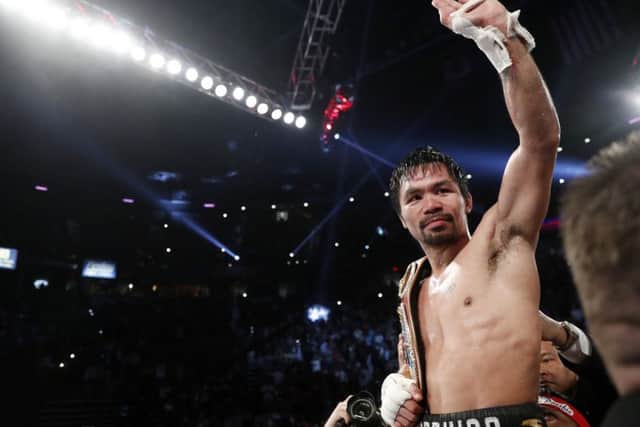 Manny Pacquiao, of the Philippines, celebrates after defeating Jessie Vargas in their WBO welterweight title boxing match, Saturday, Nov. 5, 2016, in Las Vegas. (AP Photo/Isaac Brekken)
