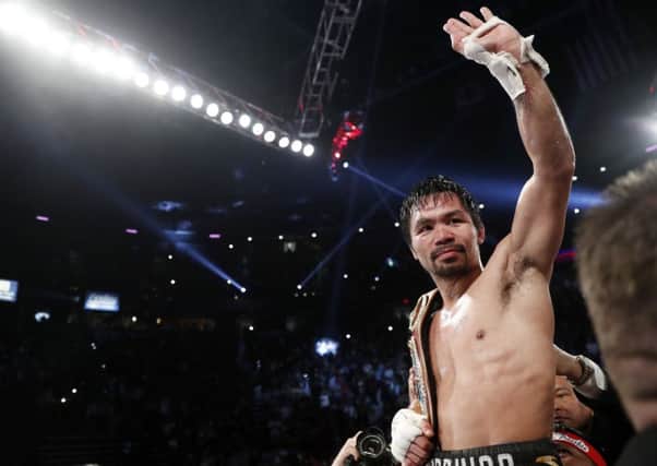 Manny Pacquiao, of the Philippines, celebrates after defeating Jessie Vargas in their WBO welterweight title boxing match, Saturday, Nov. 5, 2016, in Las Vegas. (AP Photo/Isaac Brekken)
