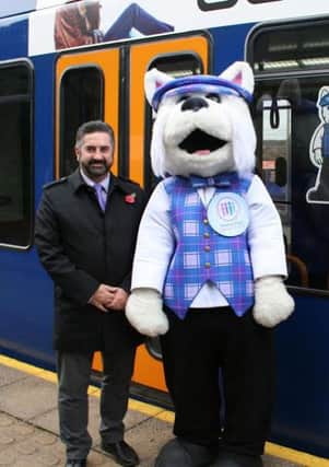 Nigel Wragg, Supertram commercial manager, Westie and Samantha Kennedy, Weston Park Cancer Charity director.