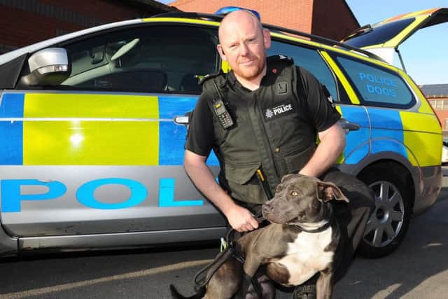Sgt Matt Duffy with a dangerous dog that is set to be put down. Picture: Andrew Roe
