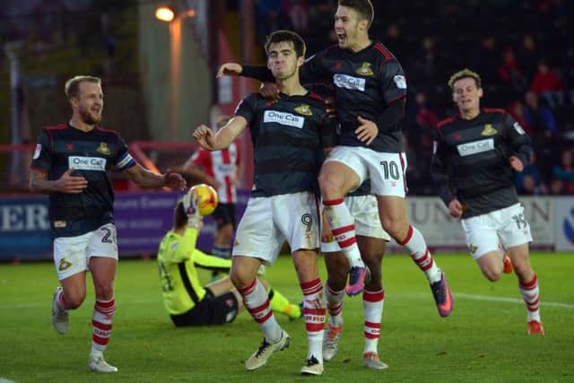 John Marquis is mobbed by team mates as he celebrates giving Rovers the lead