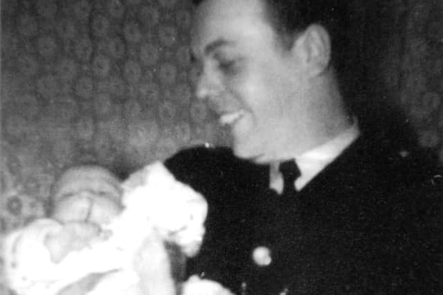'What's Tha Up To? Memories of an Attercliffe Bobby' By Martyn Johnson. In Sheffield police uniform holding a friends baby, c.1963.