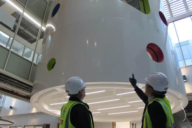 David, of the Children's Hospital Charity, gives Graham Royle a tour of the play tower in the hospital's new wing