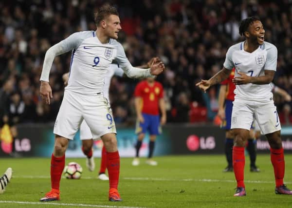 England's Jamie Vardy, centre, and Raheem Sterling, right, celebrate after Vardy scored his side's second goal