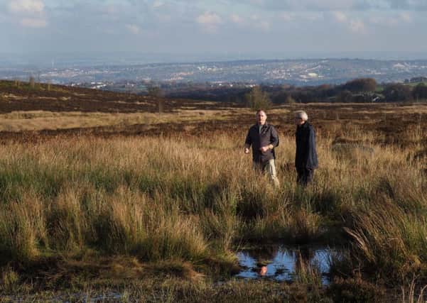 Professor Ian Rotherham and Dr Paul Ardron at the top of the Porter catchment near Ringinglow Bog with Sheffield in the background