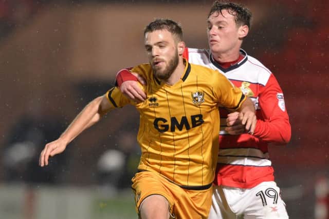 Liam Mandeville gets to grips with Port Vale's Quentin Pereira