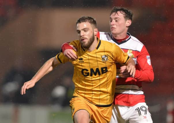 Liam Mandeville gets to grips with Port Vale's Quentin Pereira