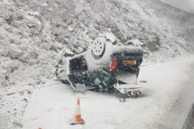 This car was flipped over on Snake Pass this morning. Photo: Chris Owen