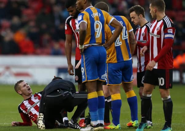 Paul Coutts of Sheffield Utd lies injured. Pic Simon Bellis/Sportimage