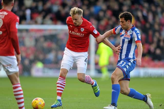 Barnsley FC v Wigan Athletic.19th November 2016.Barnsley's Marc Roberts looks to get away from Wigan's Yanic Wildschut.Picture : Jonathan Gawthorpe